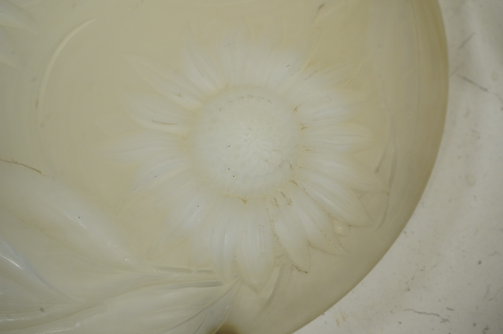 A Lalique style opalescent glass ceiling shade decorated with three sunflowers, 34cm in diameter